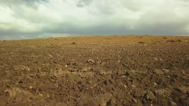aerial, drone, low flight over freshly plowed land, arable field