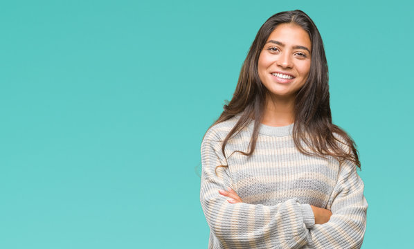 Young beautiful arab woman wearing winter sweater over isolated background happy face smiling with crossed arms looking at the camera. Positive person.