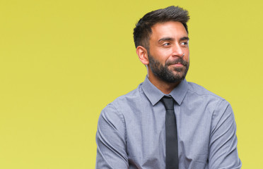 Adult hispanic business man over isolated background smiling looking side and staring away thinking.