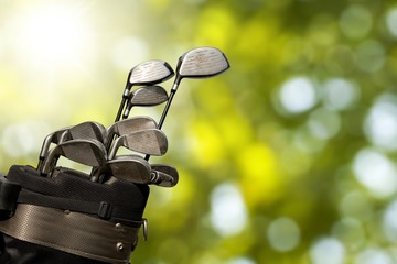 Different golf clubs on  background.