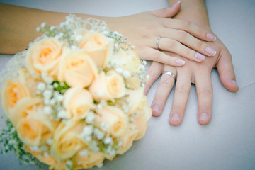 Fototapeta na wymiar Hands newlyweds on beautiful decorated wedding table. Wedding day. bridal bouquet on the table. Hands of newlyweds with wedding rings 