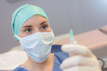 Nurse holding hypodermic needle