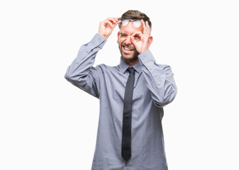 Fototapeta premium Young handsome business man over isolated background doing ok gesture with hand smiling, eye looking through fingers with happy face.