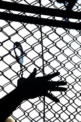 silhouette of hand in jail background.