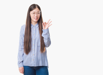 Young Chinese business woman over isolated background wearing glasses doing ok sign with fingers, excellent symbol