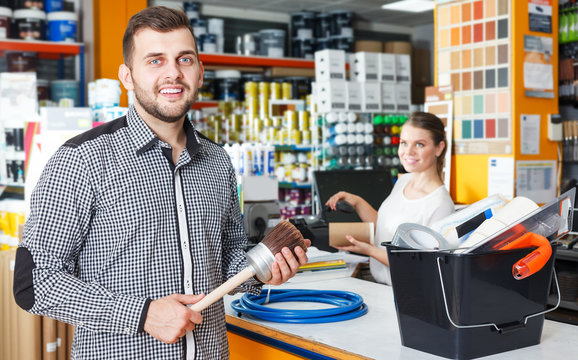 Man with purchases in household store