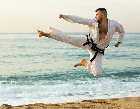 Adult man practising karate kata poses