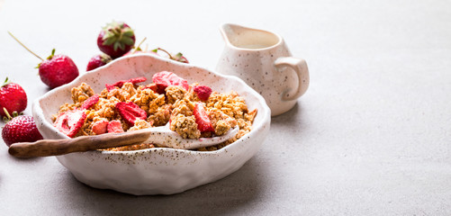 Granola Cereal bar with Strawberries on the Gray Background. Muesli Breakfast. Healthy Food sweet dessert snack. Diet Nutrition Concept. Top View. Vegetarian food.Flat Lay.Copy space for Text.