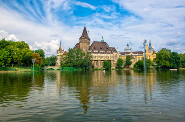 Fototapeta na wymiar Scenic view of Vajdahunyad Castle reflected in the lake under the picturesque sky in main City Park, Budapest, Hungary