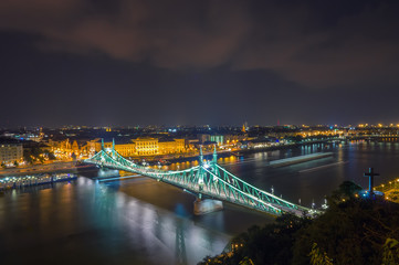Scenic night scape of Budapest. Danube river and Freedom bridge in backlight