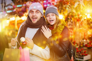 Young couple delighted with purchases at  Christmas fair