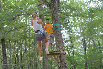 Naklejka na ściany i meble couple climbing rope at the adventure park