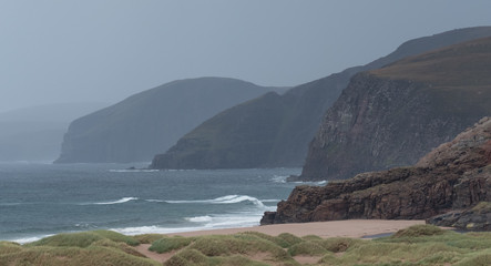 Sandwood Bay, Highlands of Scotland. Remote bay with white sand, dunes and reeds. Located on the far north west Scottish coast. Photographed on a very overcast and rainy day.