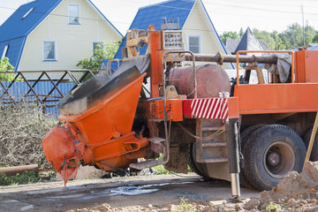 close up view of the flowing concrete from concrete mixer machine to the pump