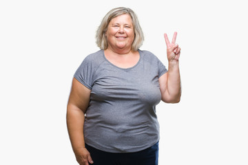 Senior plus size caucasian woman over isolated background smiling with happy face winking at the camera doing victory sign. Number two.