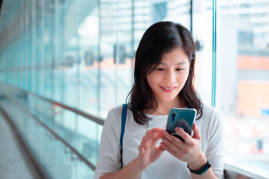 Girl Use Smartphone Inside Hong Kong West Kowloon Railway Station