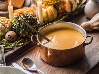 Table setting for Thanksgiving. Autumn table with pumpkins and candles in the center