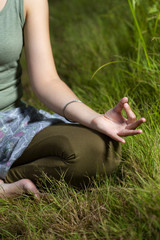 mudra of hand  young woman are folded in a special way into a yoga. Behind a strongly blurred background