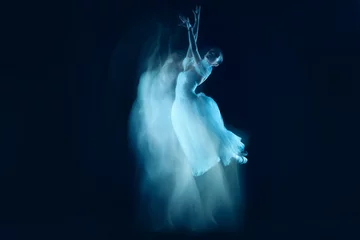 Fotobehang The photo as art - a sensual and emotional dance of beautiful ballerina through the veil on a dark background. A stroboscopic image of the one model © master1305