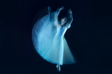 The photo as art - a sensual and emotional dance of beautiful ballerina through the veil on a dark background. A stroboscopic image of the one model © master1305