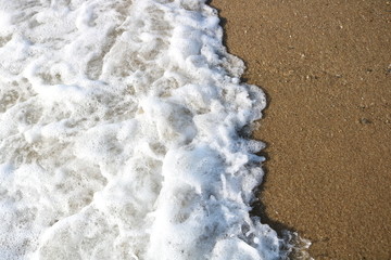 
    Soft wave of turquoise sea water on the sandy beach.