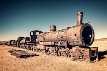 Fototapeta na wymiar Old rusty locomotive abandoned in the train cemetery of Uyuni, Bolivia