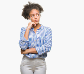 Young afro american woman over isolated background with hand on chin thinking about question, pensive expression. Smiling with thoughtful face. Doubt concept.