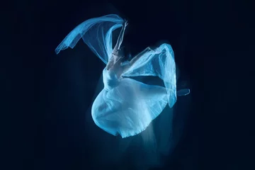 Fotobehang The photo as art - a sensual and emotional dance of beautiful ballerina through the veil on a dark background. A stroboscopic image of the one model © master1305