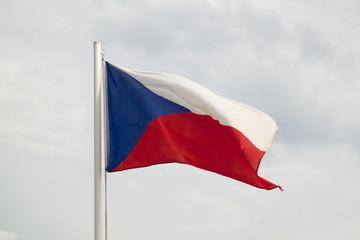 Czech Republic flag on a blue sky with clouds background