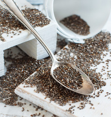Chia seeds with a wooden spoon