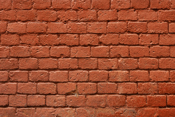 Brick wall of a vintage Moscow house painted in red paint