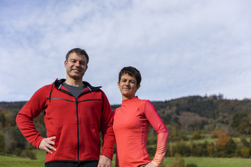 Young sportive couple wearing sports clothes posing in the Bavarian National Park, Bavaria, Germany