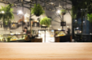 Selected focus empty brown wooden table and Coffee shop or restaurent blur background with bokeh image. for your photomontage or product display