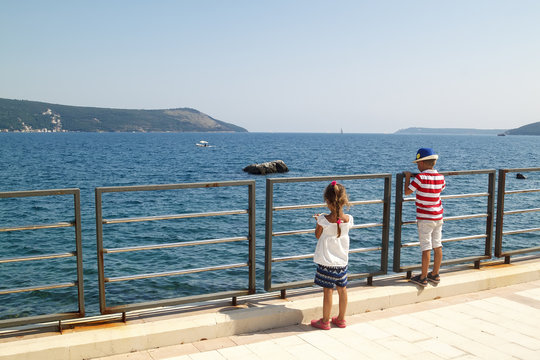 children is depicted on embankment with a breathtaking spectacular view of the Boka-Kotorska bay from Herceg Novi, Montenegro
