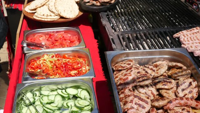 Vegetables and grilled meat dishes layout showcase on street food festival