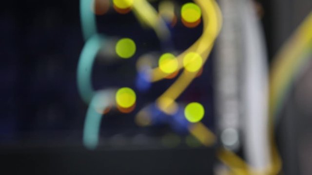 Server front side showing colorful switches and wiring Abstract blurred image for use as a background Close-up
