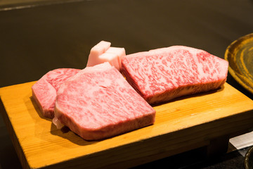 Kobe premium beef A5 on the left, and A4 on the right, place on a wooden stand for comparison, and ready to cook