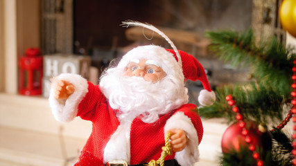 Closeup image of Santa Claus miniature under Christmas tree