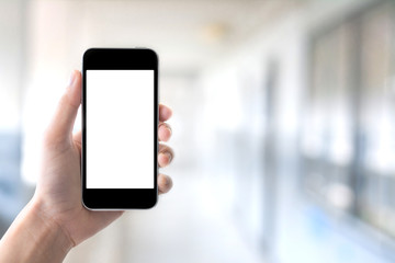 Hand holding smartphone on abstract bokeh background