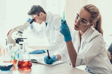 Fototapeta premium Young Scientists examining Samples in Laboratory