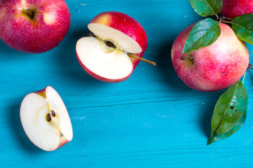 group of juicy apples lies on a wooden background