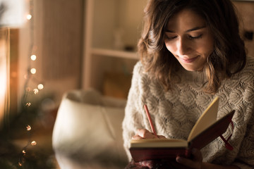 Woman writing on sketchbook