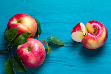 The cut apple lies on a wooden table next to the harvested fruit crop