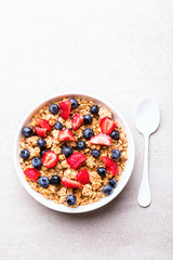 Granola Cereal bar with Strawberries and blueberries  on the Gray Background . Muesli  Breakfast. Healthy Food sweet dessert snack. Diet Nutrition Concept. Vegetarian food. Top View. Copy space