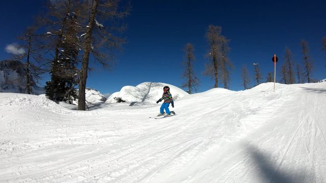 Little boy skiing.
A 5 year old child enjoys a winter holiday in the Alpine resort. Stabilized footage. Slow motion.
