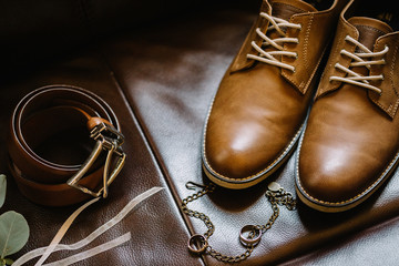Closeup of elegant stylish brown male shoes. Preparation for wed