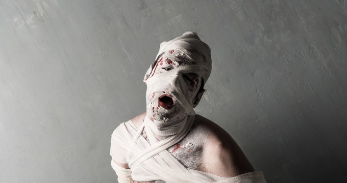 Terrorific mummy on textured wall background.  Halloween holidays