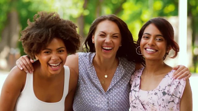 leisure and friendship concept - portrait of happy women or friends in summer park