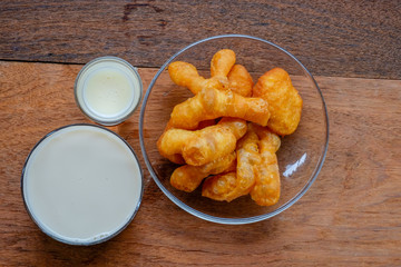 soybean milk and deep-fried dough stick on wood background, Thai style breakfast