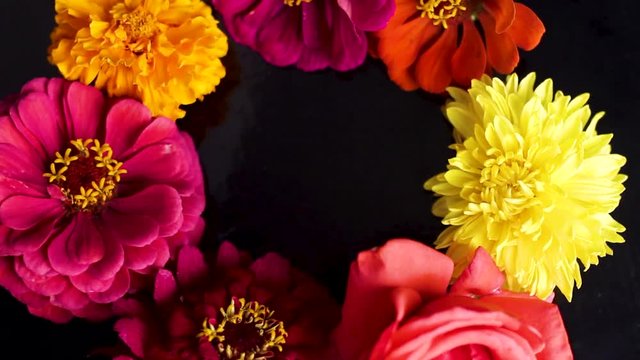 A bouquet of flowers spinning on a black background. Close up.
